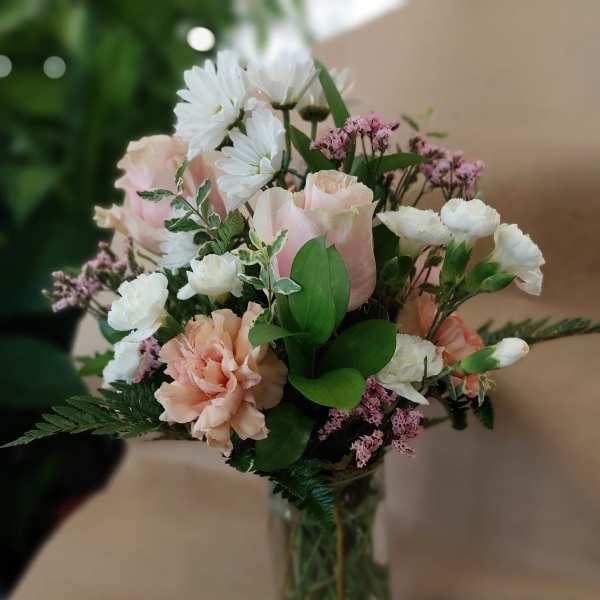 Pink and white bouquet in a clear glass vase