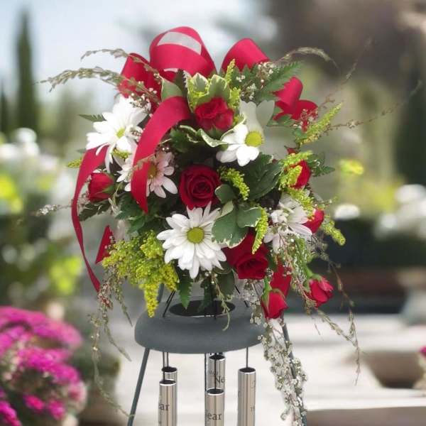 Red roses and white daisies in a hanging wind chime arrangement