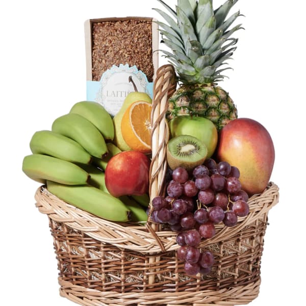 Fruit basket with bananas, pineapple, grapes, mango, apple, kiwi, and citrus