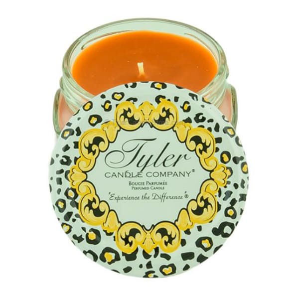 Orange candle in a glass jar with a patterned lid