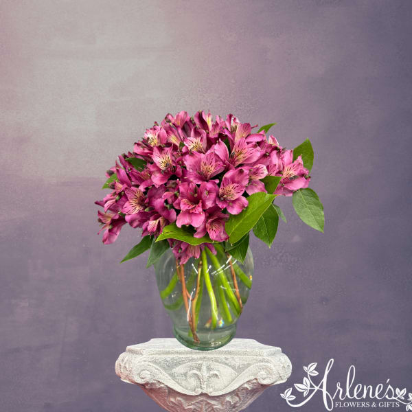Pink alstroemeria bouquet in a clear glass vase