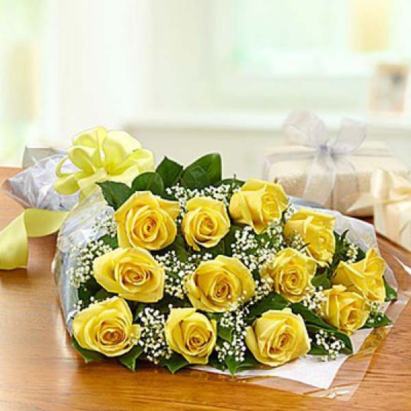 Bouquet of yellow roses wrapped in clear paper