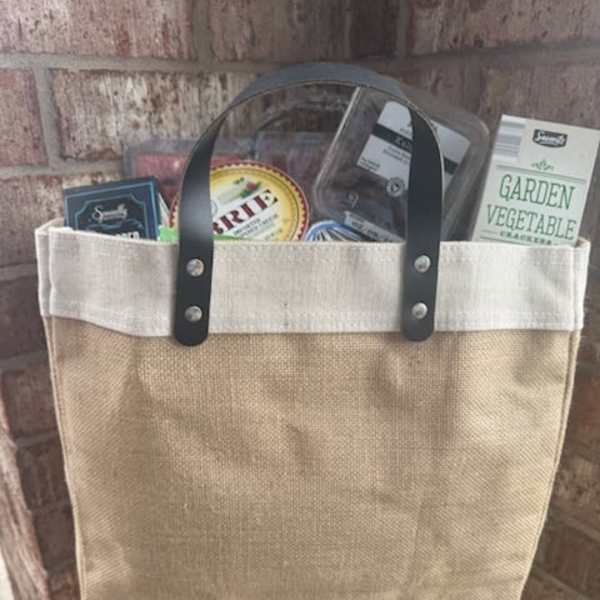 Canvas tote bag filled with packaged food items and a garden vegetable cracker box