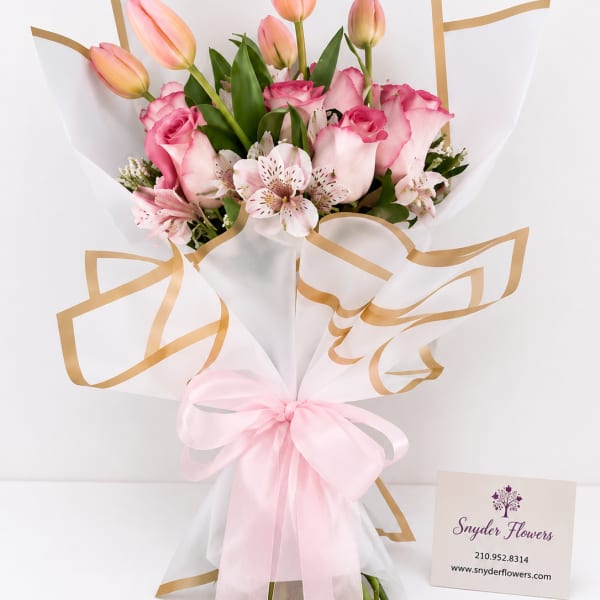 Pink tulips and roses in white wrap with a pink ribbon