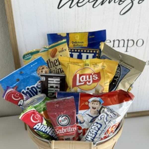 Basket filled with assorted snack bags and candy packages