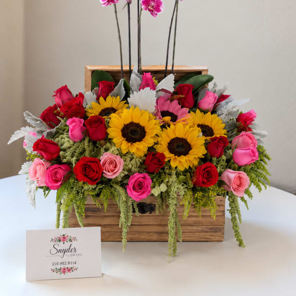 Wooden box arrangement with roses, sunflowers, and pink orchids