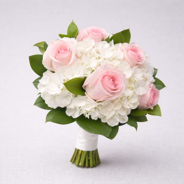 Pink roses and white hydrangeas in a hand-tied bouquet
