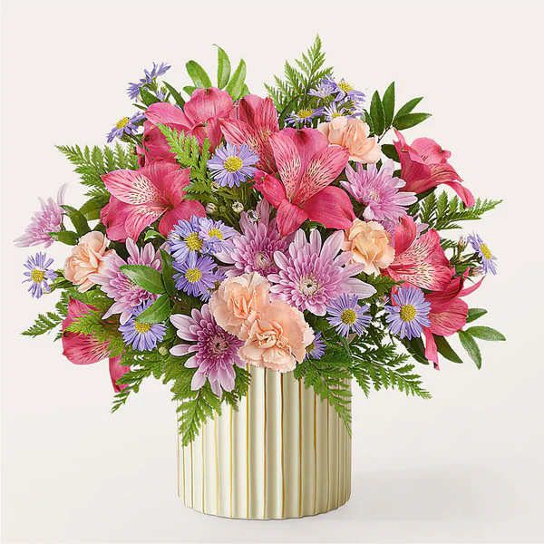 Pink and lavender mixed bouquet in a striped gold vase