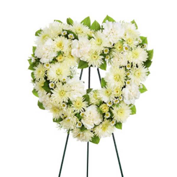 White floral funeral wreath on a standing easel