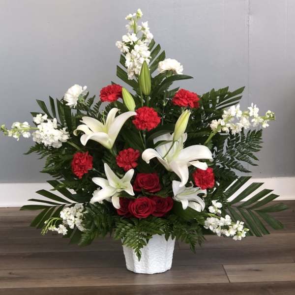 White lilies and red roses in a white vase