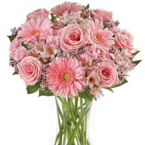 Pink roses and gerbera daisies in a clear glass vase