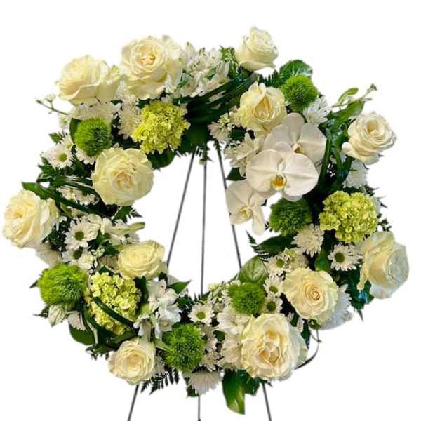 Cream rose and orchid wreath on a standing easel