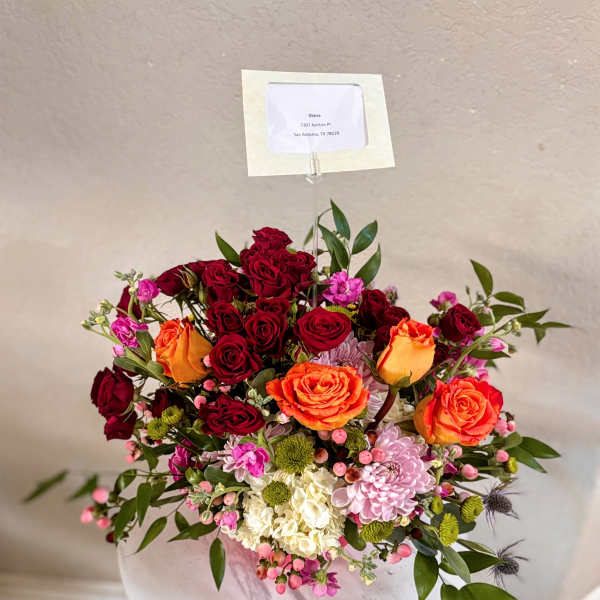 Mixed bouquet of red and orange roses with pink and white flowers