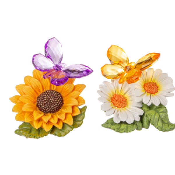 Two small floral figurines with sunflowers and daisies topped by butterfly accents