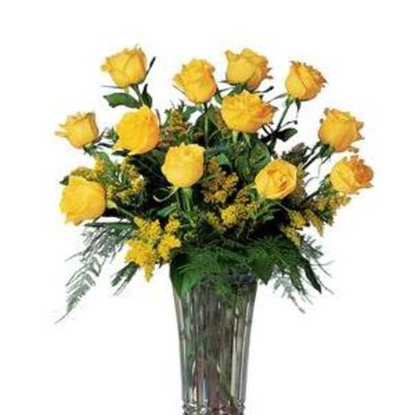 Yellow roses arranged in a tall glass vase