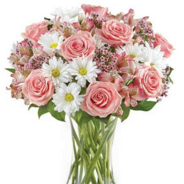 Pink roses and white daisies in a clear glass vase