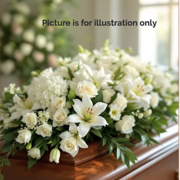 White floral casket spray with lilies and roses