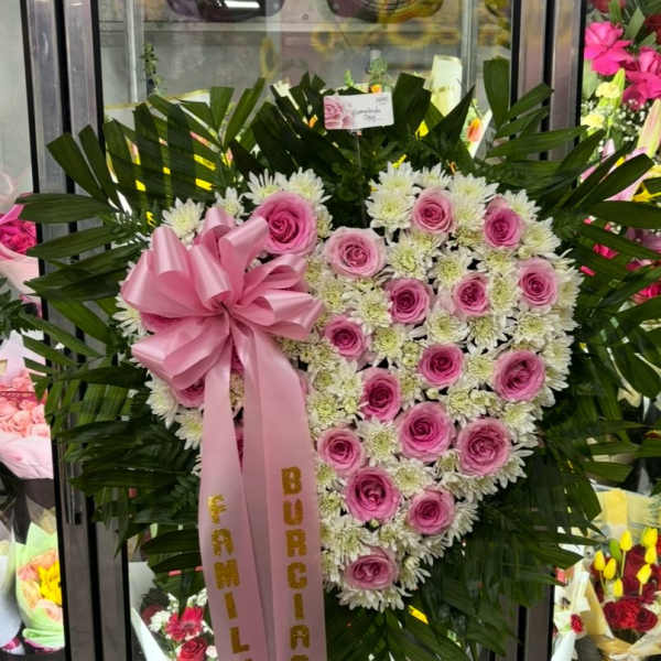 Heart-shaped pink rose and white chrysanthemum standing spray with a pink ribbon