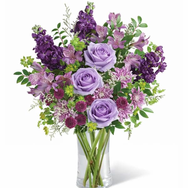 Lavender and purple bouquet in a clear glass vase