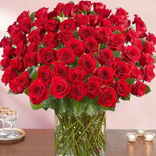 Large bouquet of red roses in a clear glass vase