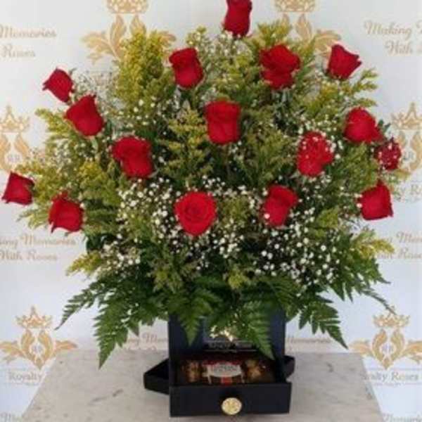 Red roses arranged in a black box with baby's breath