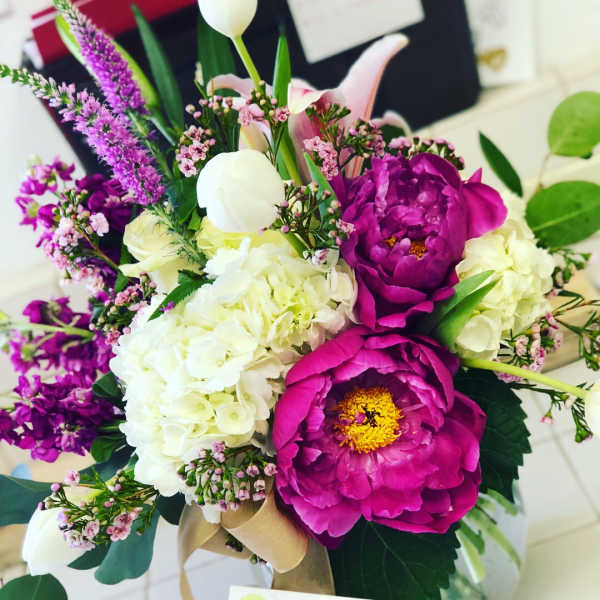 Bouquet of magenta peonies, white hydrangeas, and pink accent flowers