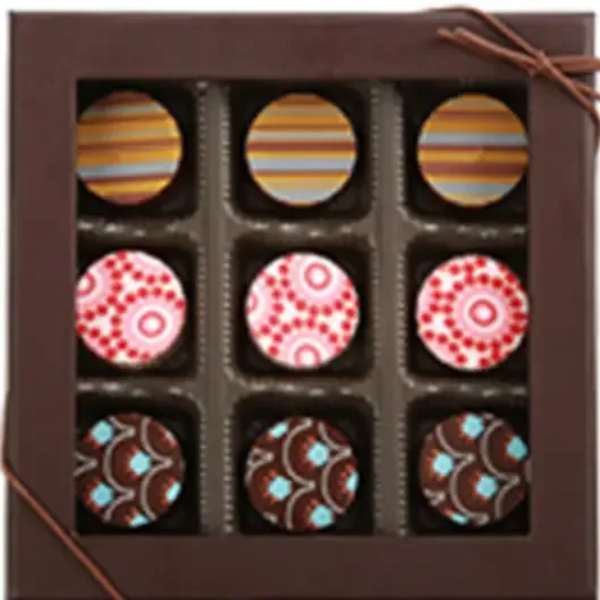 Box of assorted decorated chocolates with striped and patterned tops