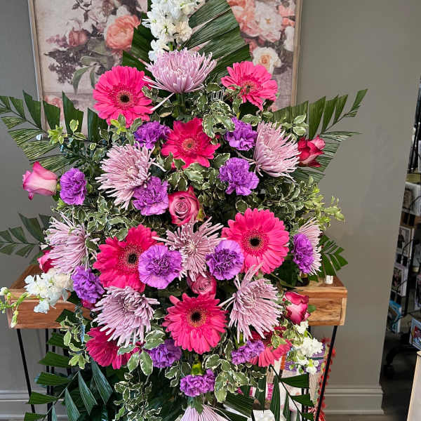 Large standing floral spray with pink, purple, and white flowers