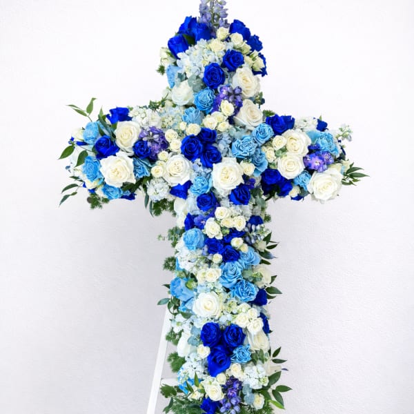 Blue and white floral cross on a white stand