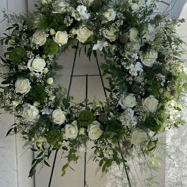 Large white rose wreath on a metal easel