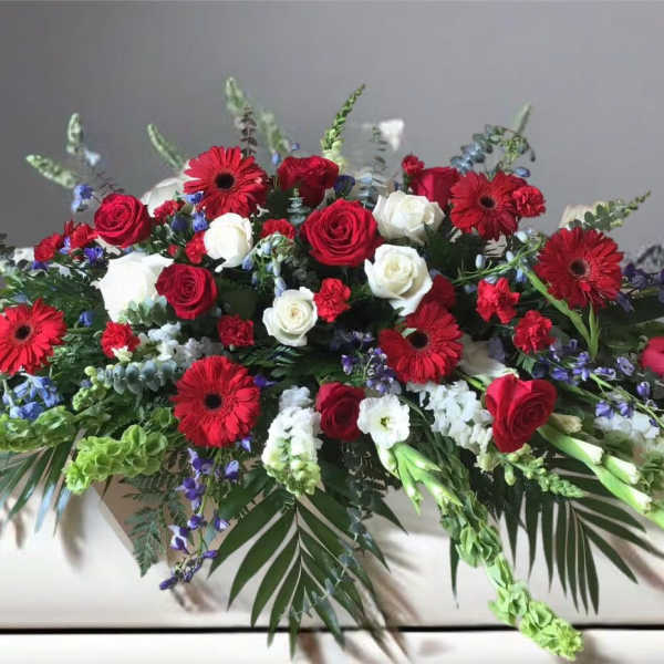 Large arrangement of red and white roses with red gerbera daisies