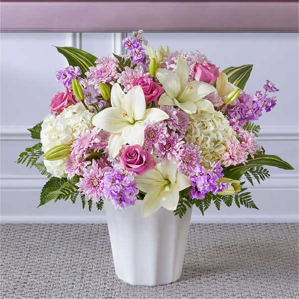 Pink and white floral arrangement in a white vase