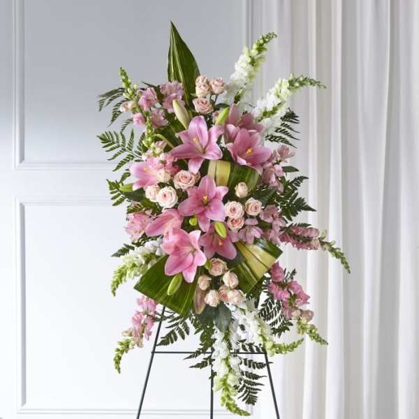 Tall pink floral spray with lilies and roses on a stand