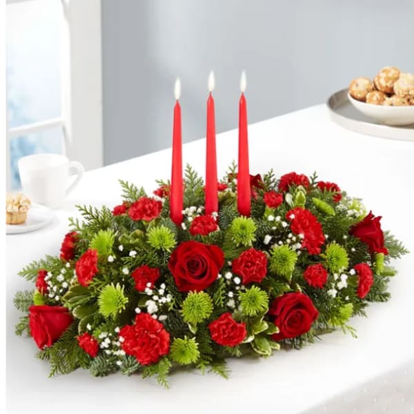 Red roses and carnations arranged with three red candles