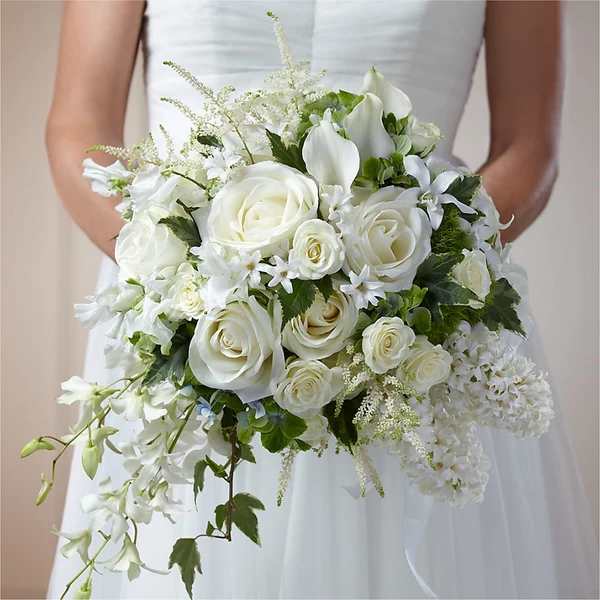 Bride holding a white bouquet of roses, calla lilies, and orchids