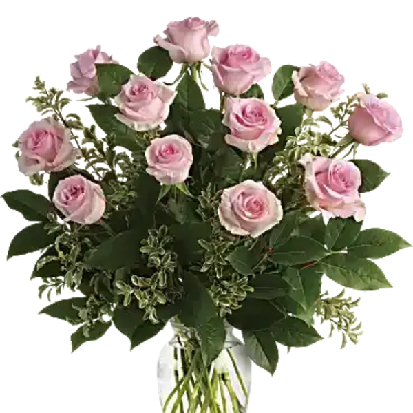 Arrangement of light pink roses in a clear glass vase with visible stems