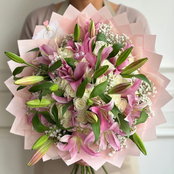 Pink lilies and white roses in a pale pink wrap