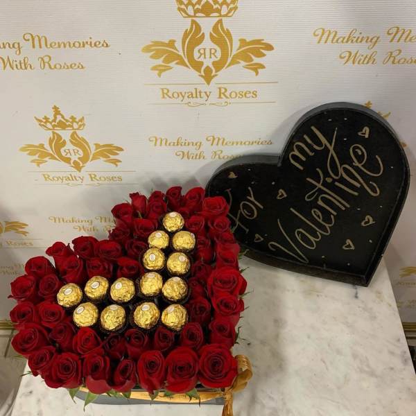 Heart-shaped box of red roses with gold-wrapped chocolates and a matching lid