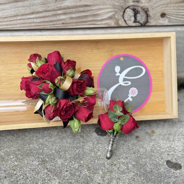 Red rose bouquet and matching boutonniere on a wooden tray
