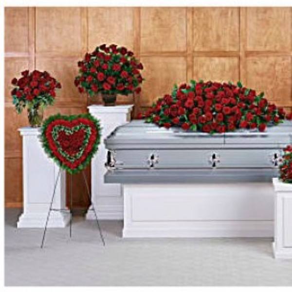 Red rose funeral casket spray with matching standing arrangements