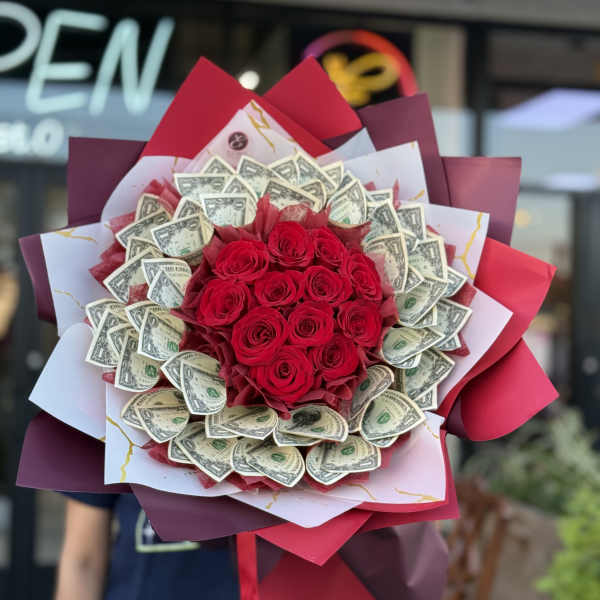 Bouquet of red roses wrapped with dollar bills and burgundy paper