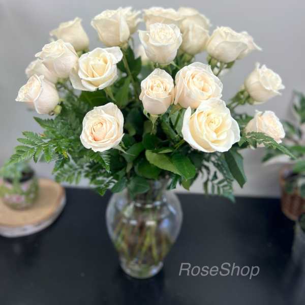 Cream roses arranged in a clear glass vase