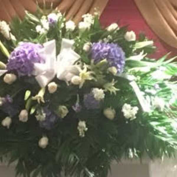 Large funeral spray with purple and white flowers
