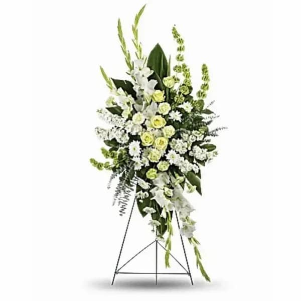 Standing floral spray of white and pale green flowers on a metal easel