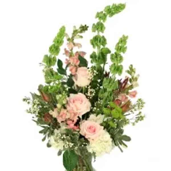 Tall pink and white floral arrangement in a clear glass vase