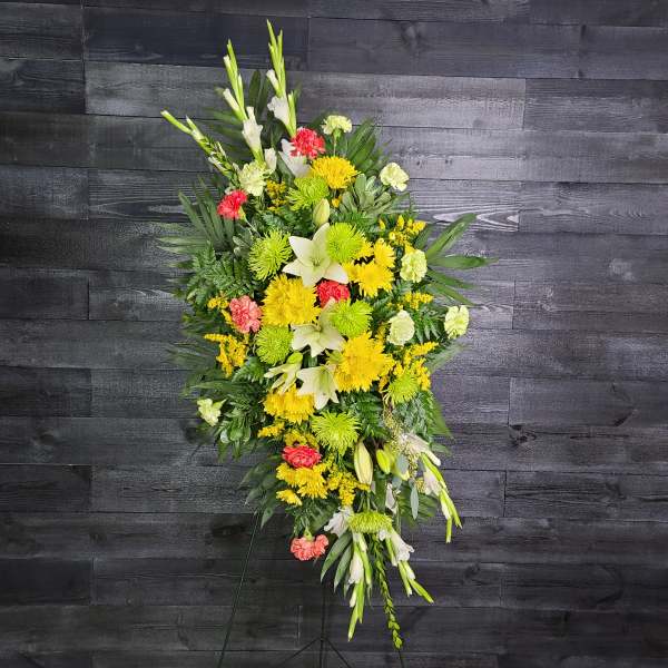 Tall standing floral spray with yellow, white, and coral flowers