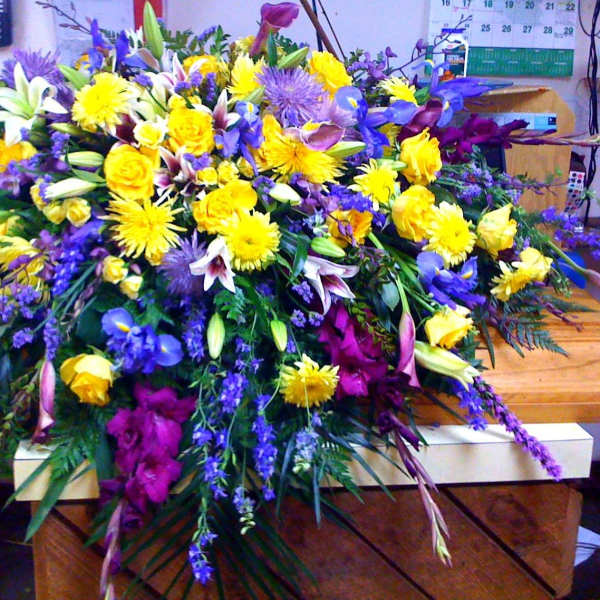 Large mixed floral spray with yellow, purple, and white blooms