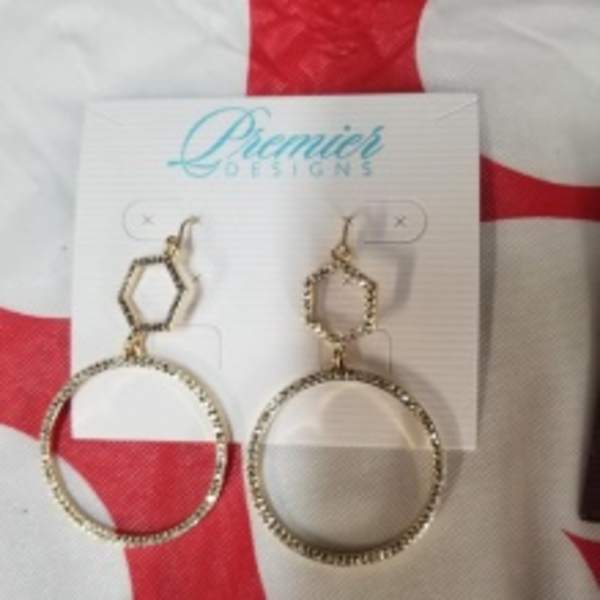 Pair of gold-tone hoop earrings on a display card