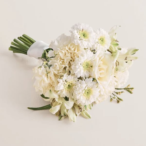 White bouquet with daisies, roses, and lilies tied with a white wrap