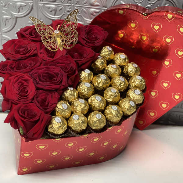 Heart-shaped box with red roses and gold-wrapped chocolates
